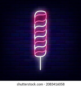 Long striped candy neon icon. Big sweetmeat. Sweet shop logo. Night bright signboard on brick wall background. Luminous label. Outer glowing effect emblem. Editable stroke. Vector stock illustration