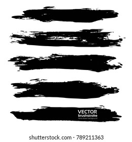 Long thick abstract black hand-drawn brush strokes isolated on a white background