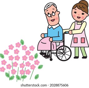 A long-term care woman pushing a wheelchair on which an elderly man rides 