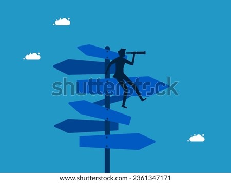 Look at ideas for solving the right business problems. Businessman using binoculars on road sign 