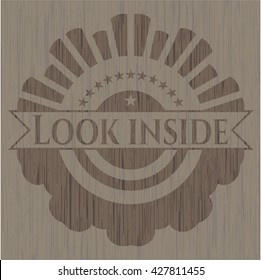 Look inside badge with wooden background