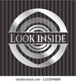 Look inside silver emblem or badge