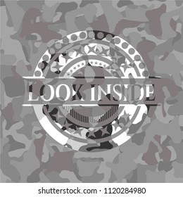 Look inside written on a grey camouflage texture