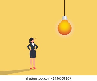 Looking for creativity concept. Businesswoman standing below light bulb.