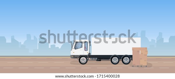 Lorry and pallet with boxes. A truck is standing\
on the road. Carton boxes. The concept of delivery and loading of\
cargo. Vector.