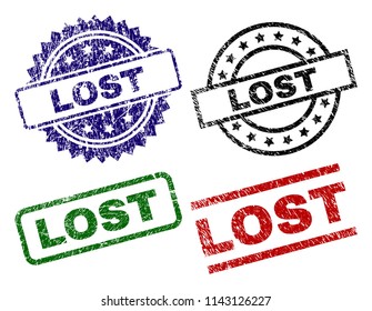 LOST seal prints with damaged texture. Black, green,red,blue vector rubber prints of LOST caption with retro texture. Rubber seals with circle, rectangle, medallion shapes.