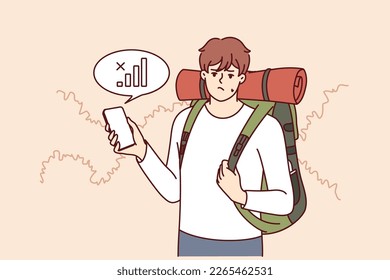 Lost traveler with backpack on back is looking for mobile network to find way home. Guy tourist got lost in forest and was sad when learned about lack of communication or bad GPS signal