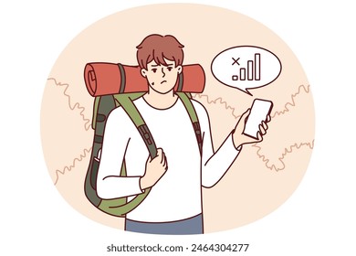 Lost traveler with backpack on back is looking for mobile network to find way home. Guy tourist got lost in forest and was sad when learned about lack of communication or bad GPS signal