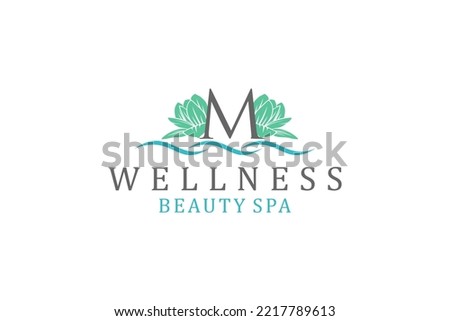 Lotus flower logo design M letter initial wellness spa massage healthcare therapy icon symbol