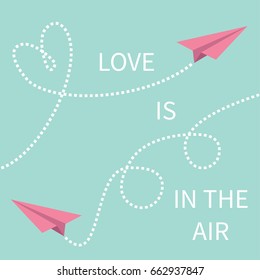 Love is in the air Lettering text. Two pink flying origami paper plane Dashed line Heart loop Happy Valentines day Greeting card Typographical blue sky background with quote Flat design Vector