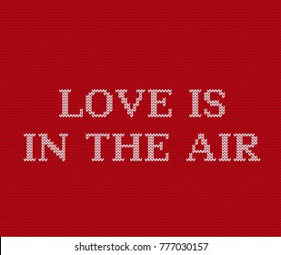 Love is in the air. Phrase for Valentine's day. Vector graphics. Valentine background. Knit seamless pattern. Knitting design. Knitted red sweater ornament. 