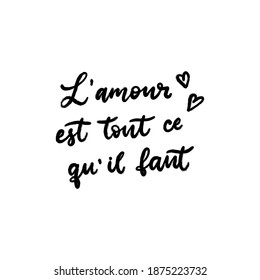 Love is all we need text in French language. Inspirational phrase. Calligraphic lettering motivational inscription in black and white colors for postcard, poster, wallpaper. Vector illustration.