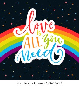 Love is all you need. Words on rainbow parade flag at dark sky with stars. Gay pride saying for stickers, t-shirts and posters