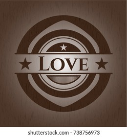 Love badge with wooden background