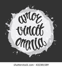 "Love conquers all" card. Inspirational latin quote Carpe Diem. Hand written calligraphy, brush painted letters. Black and white vector illustration. T-shirt print element.