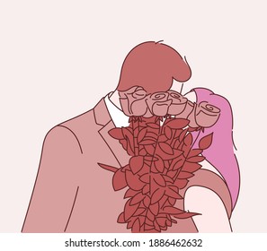 Love, dating, romance, relationship, togetherness, couple concept. The couple kisses and covers their faces with a bouquet.