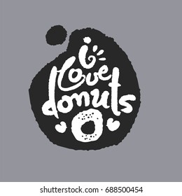 I Love Donuts. Hand written calligraphy phrase in a speech bubble. White on black. Clipping paths included.