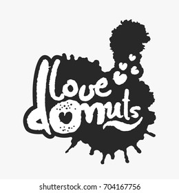 Love Donuts. Hand written calligraphy phrase in an ink blot. White on black. Clipping paths included.