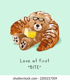 love at first bite slogan with bear doll reading a book on croissant vector illustration