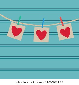 Love hearts hanging on rope on a blue wooden background