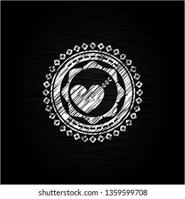 love icon inside chalkboard emblem on black board