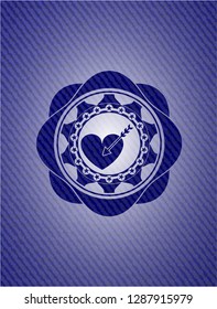 love icon inside emblem with jean background