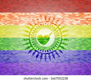 love icon inside emblem on mosaic background with the colors of the LGBT flag