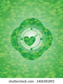 love icon inside green mosaic emblem