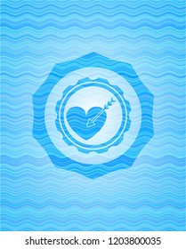 love icon inside light blue water wave style badge.
