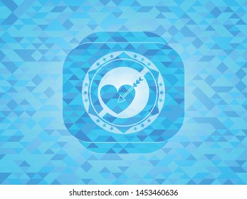 love icon inside light blue mosaic emblem
