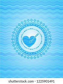 love icon inside sky blue water wave badge.