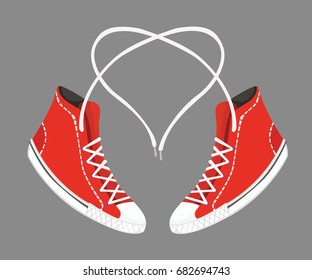 Love of sneakers. Red sneakers with heart shaped shoelaces.