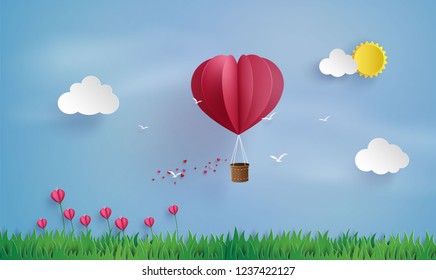 
 love and valentine day,Origami made hot air balloon fly over grass .paper art style.