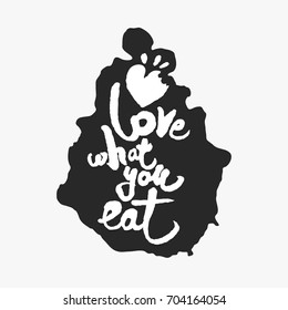 Love What You Eat. Hand written calligraphy phrase in an ink blot. White on black. Clipping paths included.