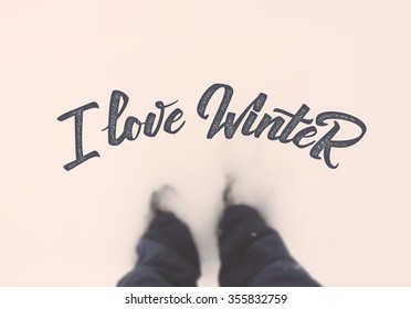 I love winter  calligraphic quotation on blurred background feet in the snow