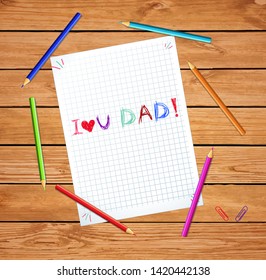 I love you dad Kids hand drawn vector inscription on checkered notebook sheet or graphing paper on wooden table with colored pencils around. Fathers day greeting card, title, template, typography