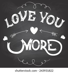 Love you more Valentines day hand-lettering on blackboard background with chalk