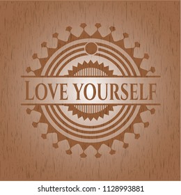 Love Yourself badge with wooden background