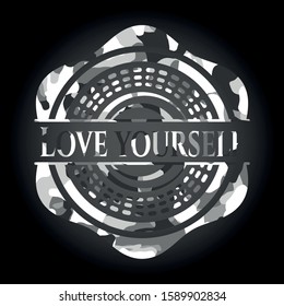 Love Yourself written on a grey camouflage texture