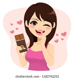 Lovely brunette woman eating chocolate bar naughty face expression