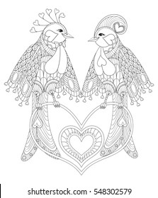 Lovely couple of exotic bird sitting on heart for adult anti stress coloring page,  St Valentine day greeting card, art therapy, decoration element. Hand drawn zentangle lovebirds illustration.