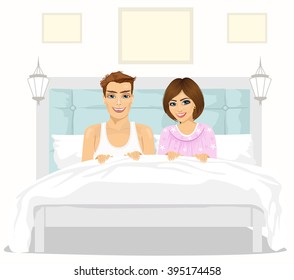 Lovely couple in love sitting together in bed