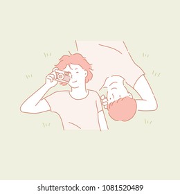 lovely couple lying on the grass. hand drawn style vector doodle design illustrations.