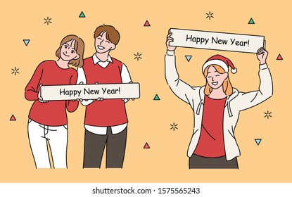 A lovely couple and a woman are holding placards with New Year's messages. hand drawn style vector design illustrations. 