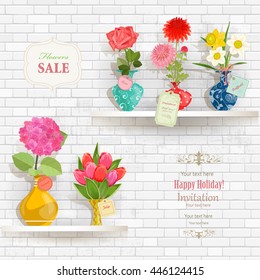 lovely flowers in modern vases for sale on shelves in a store