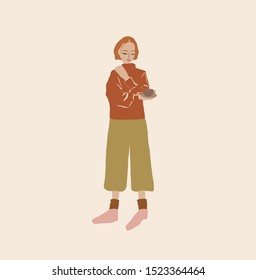 lovely girl stands and holds a cup of coffee