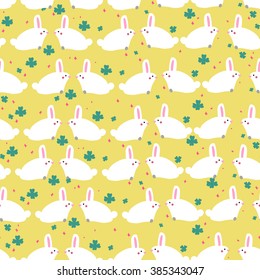 Lovely rabbits in clover and sparkles on green background. Cute childish seamless pattern in cartoon style. Vector illustration