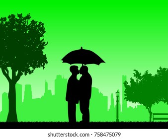 Lovely retired elderly couple standing and kissing under the umbrella in park in autumn or fall, one in the series of similar images silhouette