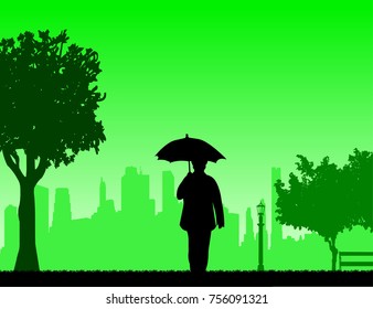 Lovely retired elderly woman walking under the umbrella in park in autumn or fall, one in the series of similar images silhouette