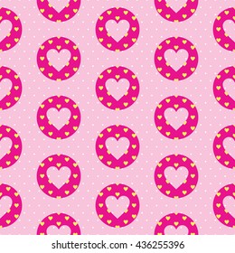 Lovely seamless pattern with a heart shape inside the circle and polka dot background. Pink and yellow colors.
